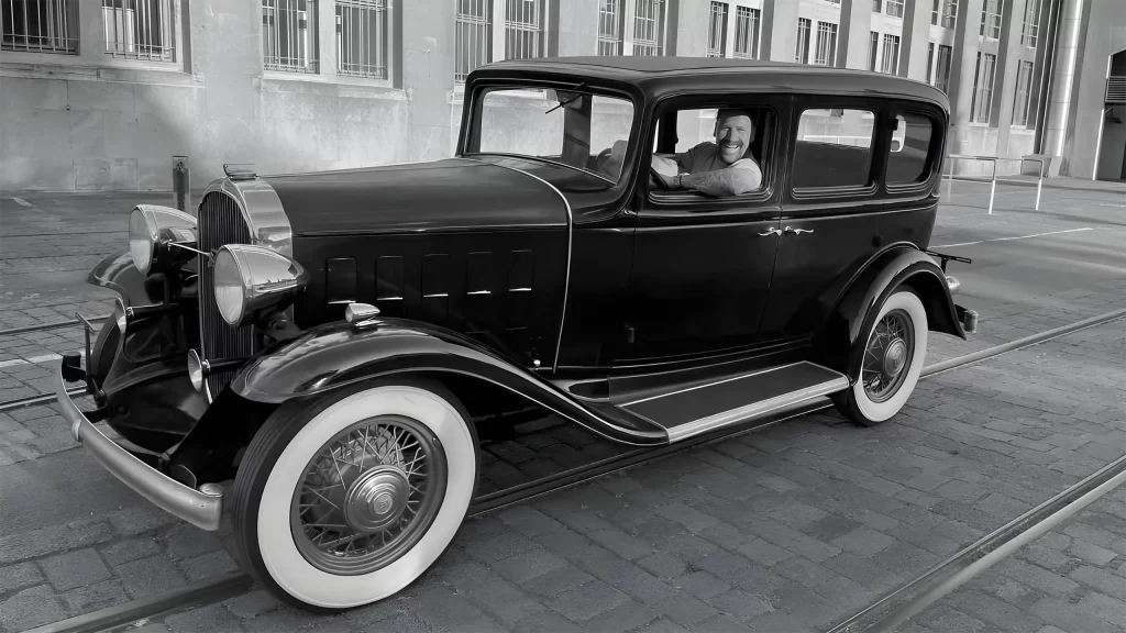 Mann im oldtimer mit runtergelassenen fenstern